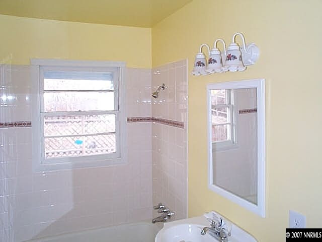 1945 Wilder Street Reno, NV 89512 - Photo 4 of 9 a bathroom with a sink a mirror and a window
