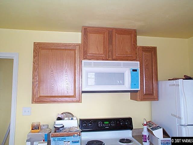 1945 Wilder Street Reno, NV 89512 - Photo 8 of 9 a bathroom with a small stove a microwave and cabinets