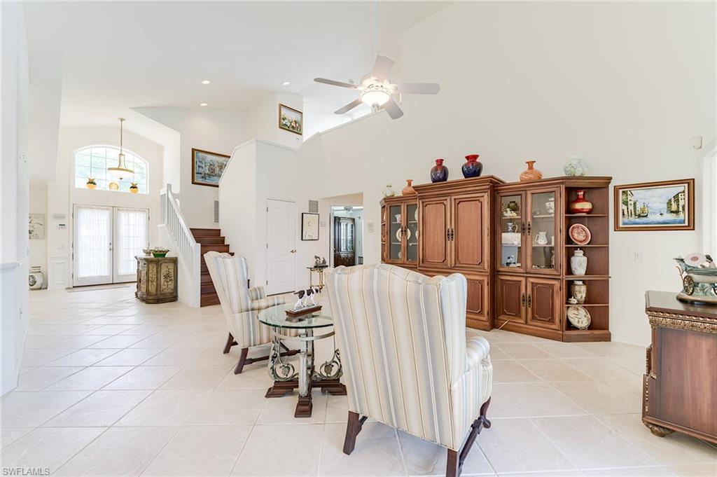 9156 Spring Run Boulevard Estero, FL 34135 - Photo 5 of 34 a living room with furniture and wooden floor