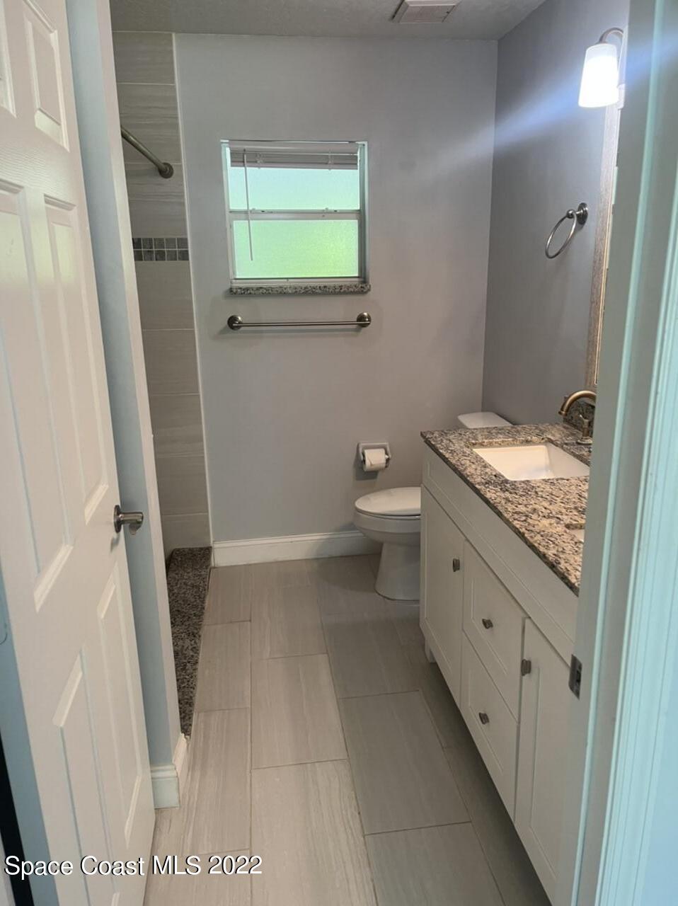 544 Plumbago Road Northwest Palm Bay, FL 32907 - Photo 13 of 16 a bathroom with a granite countertop sink and a toilet