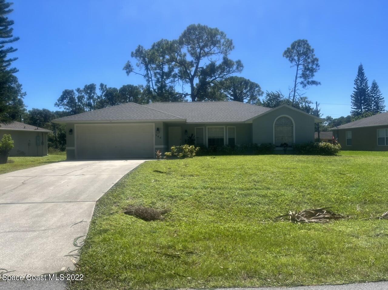 544 Plumbago Road Northwest Palm Bay, FL 32907 - Photo 2 of 16 a front view of a house with garden