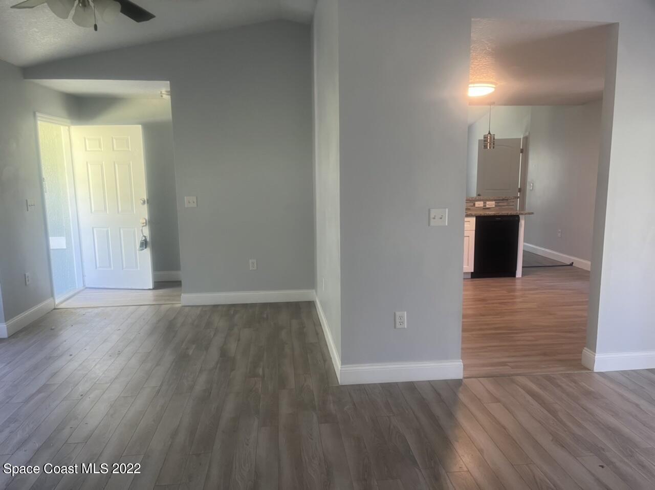 544 Plumbago Road Northwest Palm Bay, FL 32907 - Photo 5 of 16 wooden floor in an empty room with a window