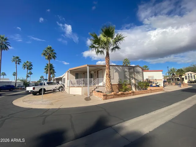 a vase of flowers sitting on a table with a chandelier