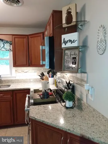 a kitchen with a sink a stove and cabinets