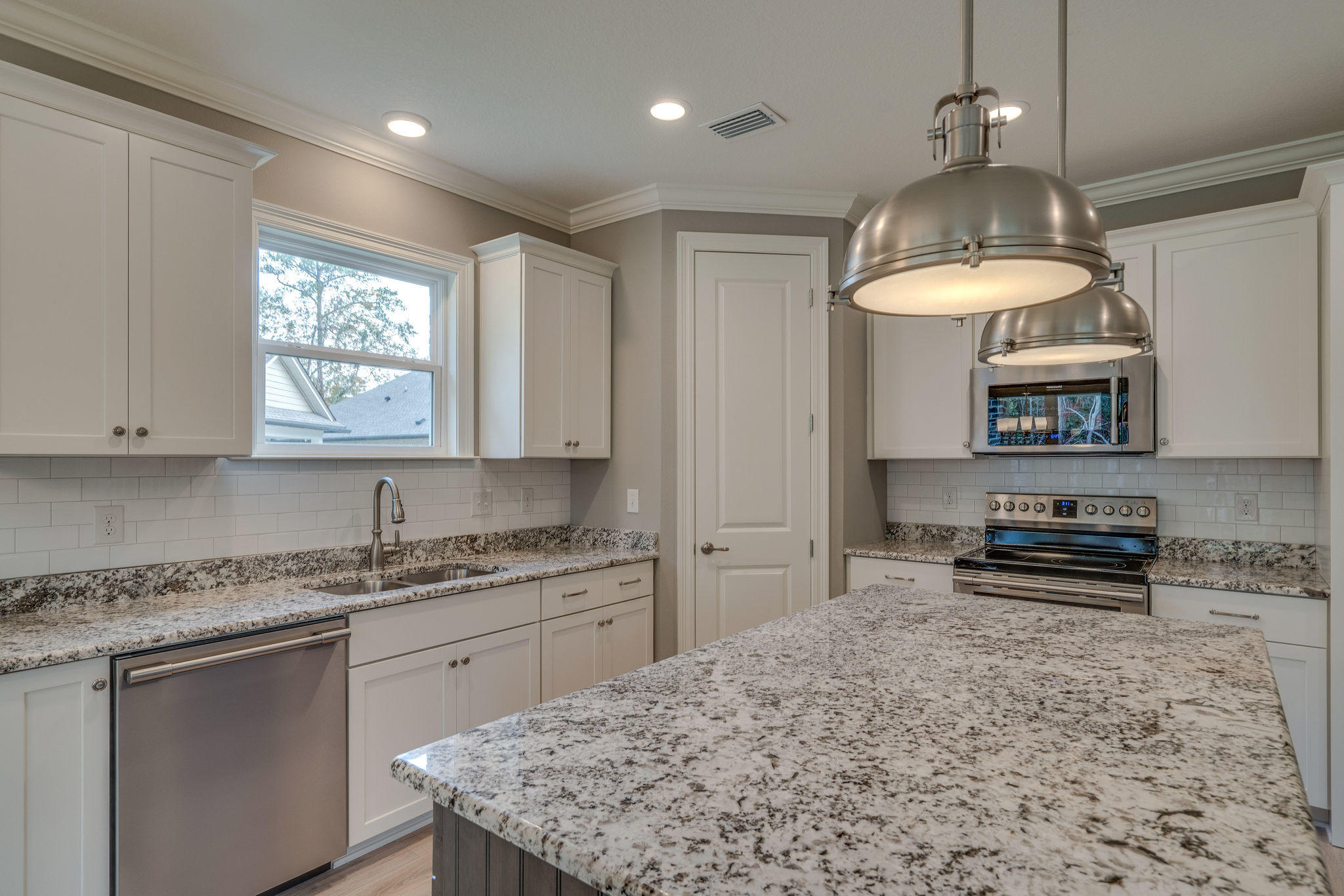 105 Creve Core Drive Crestview, FL 32539 - Photo 3 of 14 a kitchen with stainless steel appliances granite countertop a sink stove and refrigerator
