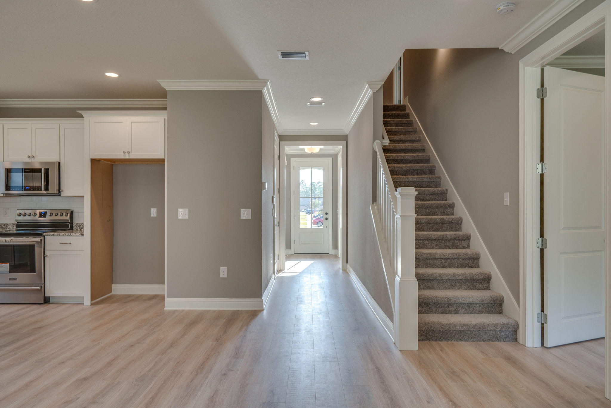 105 Creve Core Drive Crestview, FL 32539 - Photo 10 of 14 a view of a hallway with wooden floor and staircase