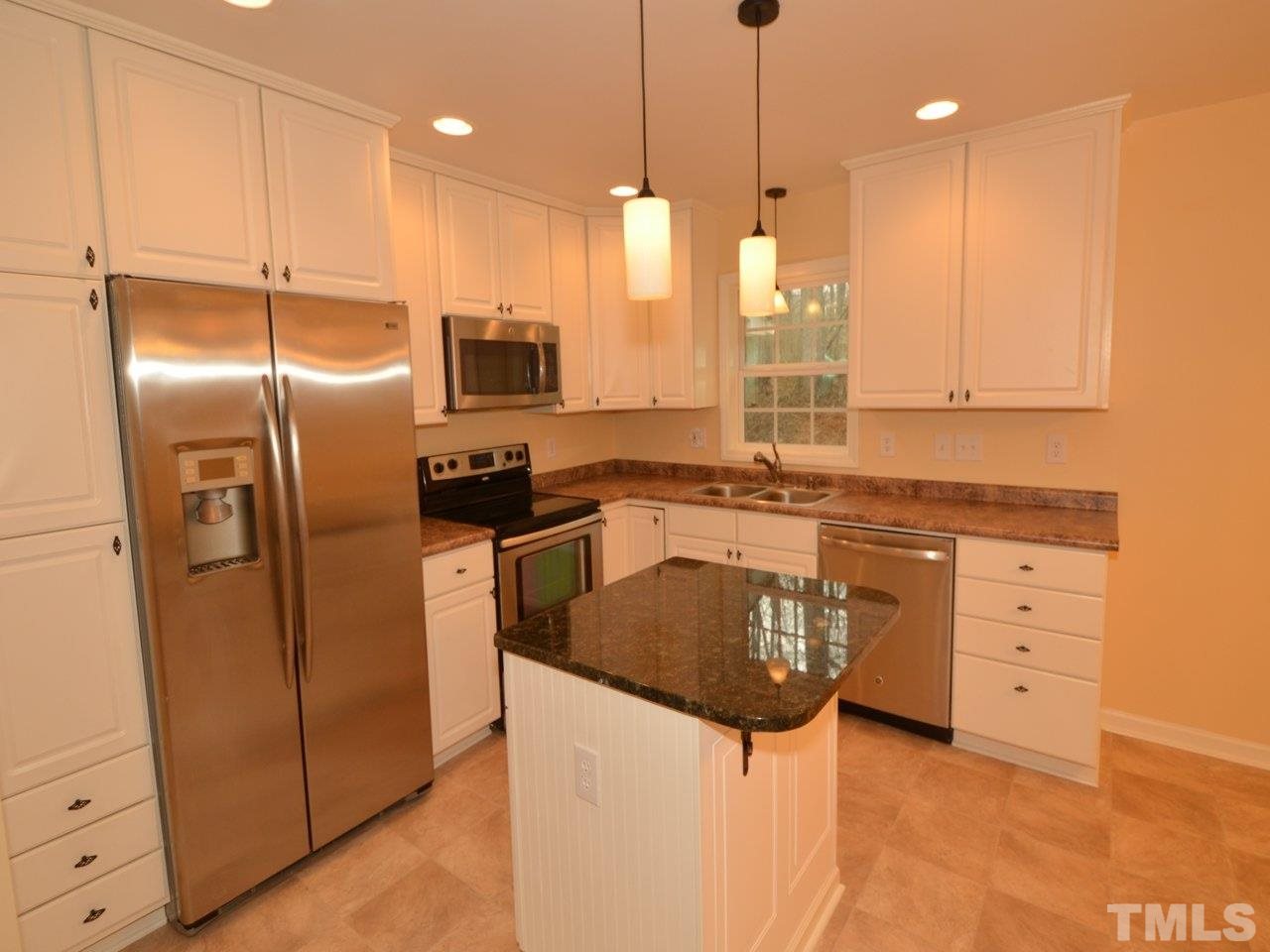 1601 Cranston Road Garner, NC 27529 - Photo 3 of 16 a kitchen with stainless steel appliances granite countertop a refrigerator a sink a stove and a refrigerator