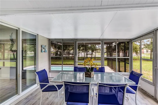 a kitchen with a table chairs and wooden floor
