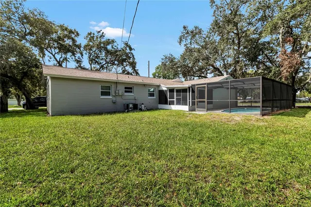 a view of a house with a backyard