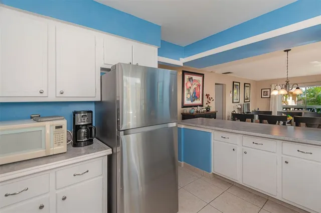 a kitchen with appliances a sink and lots of cabinets