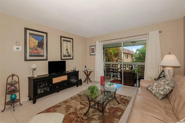 a living room with furniture a rug and a flat screen tv
