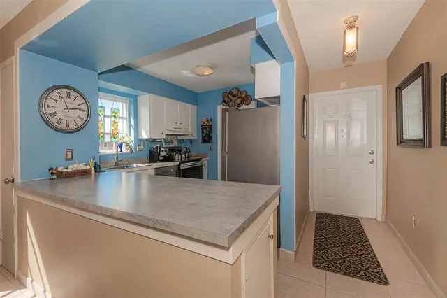 a kitchen with a refrigerator a stove and a sink