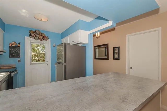 a view of a livingroom with wooden floor and hallway