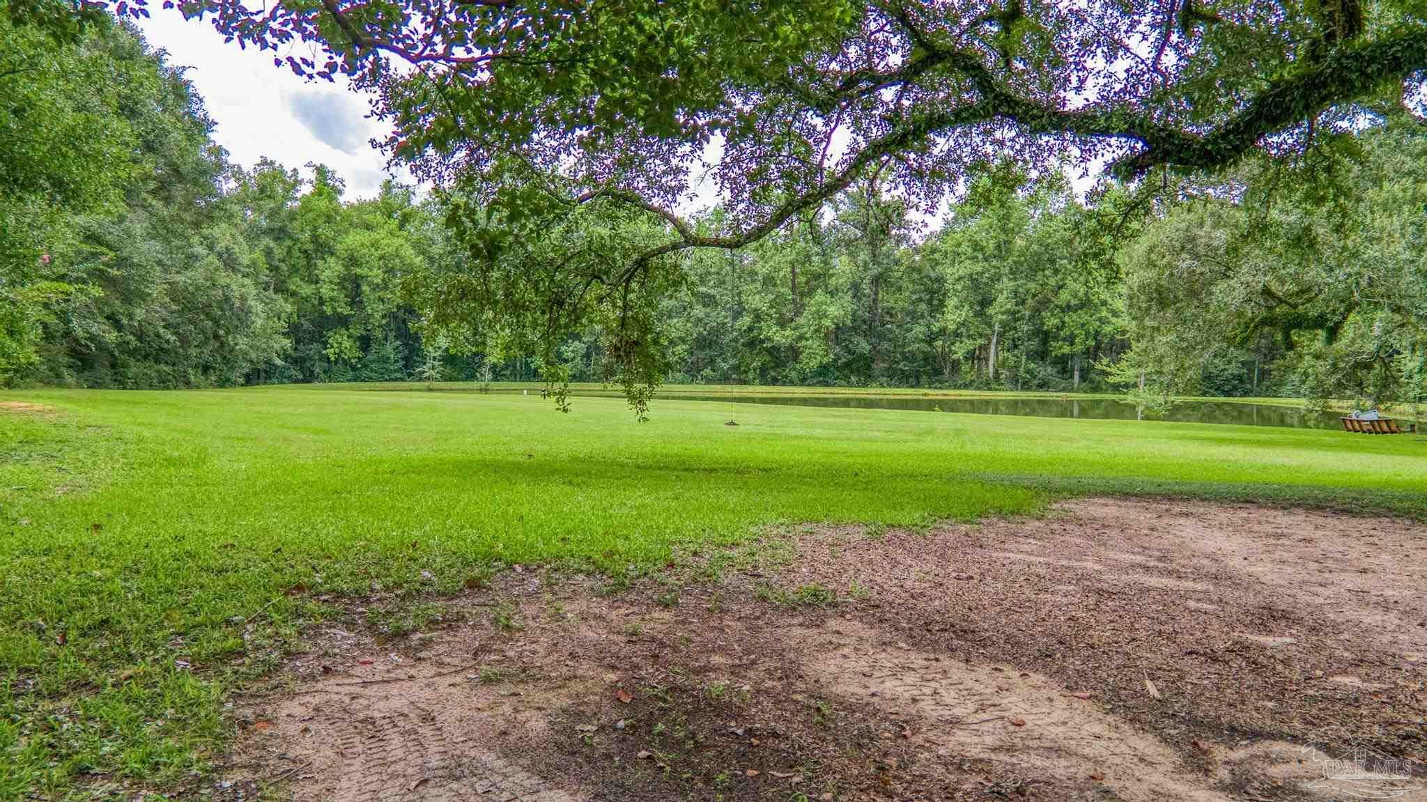 2345 Pompano Street Cantonment, FL 32533 - Photo 42 of 48 a view of a field with big trees