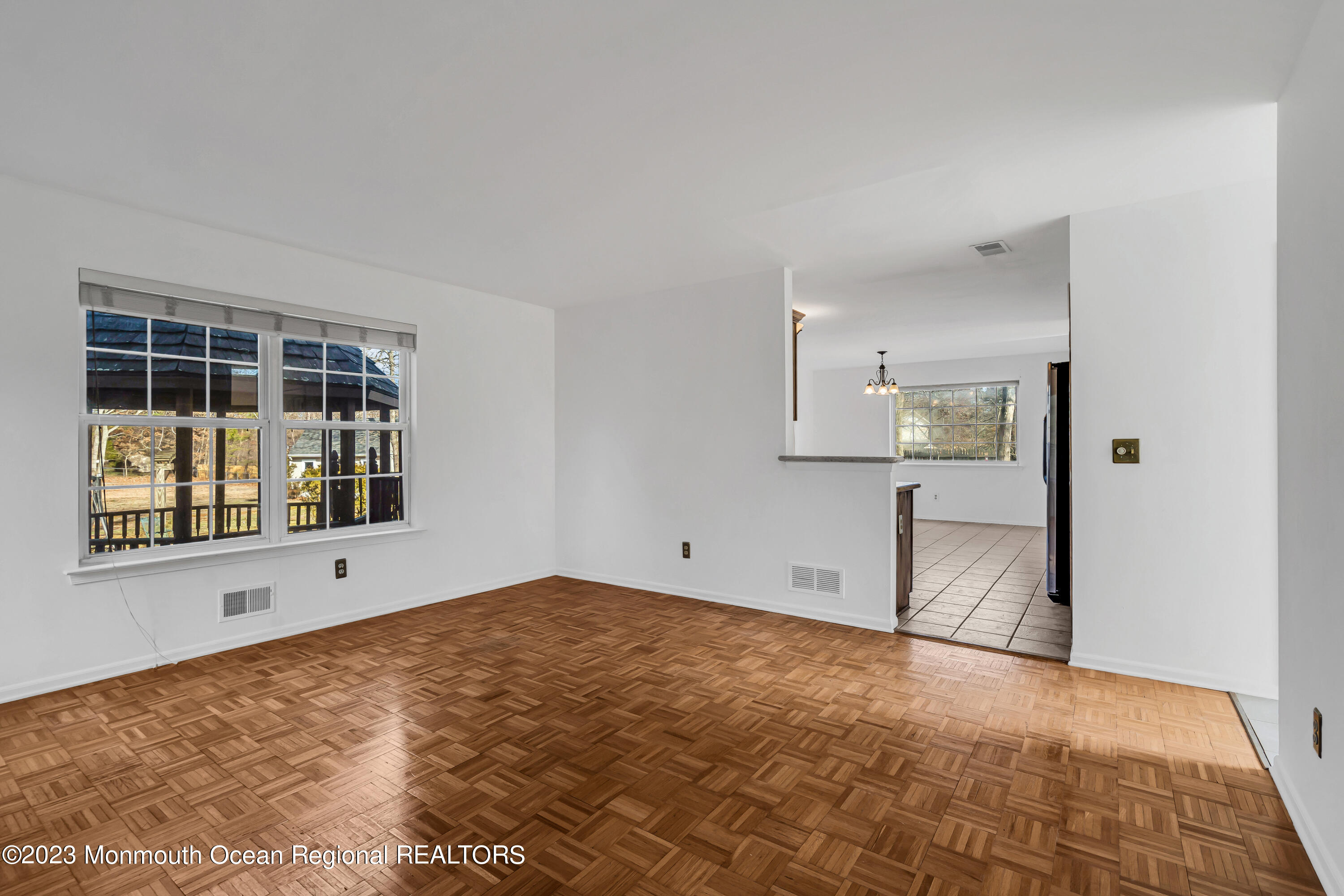796 Harmony Road Jackson, NJ 08527 - Photo 12 of 22 a view of an empty room with window and wooden floor