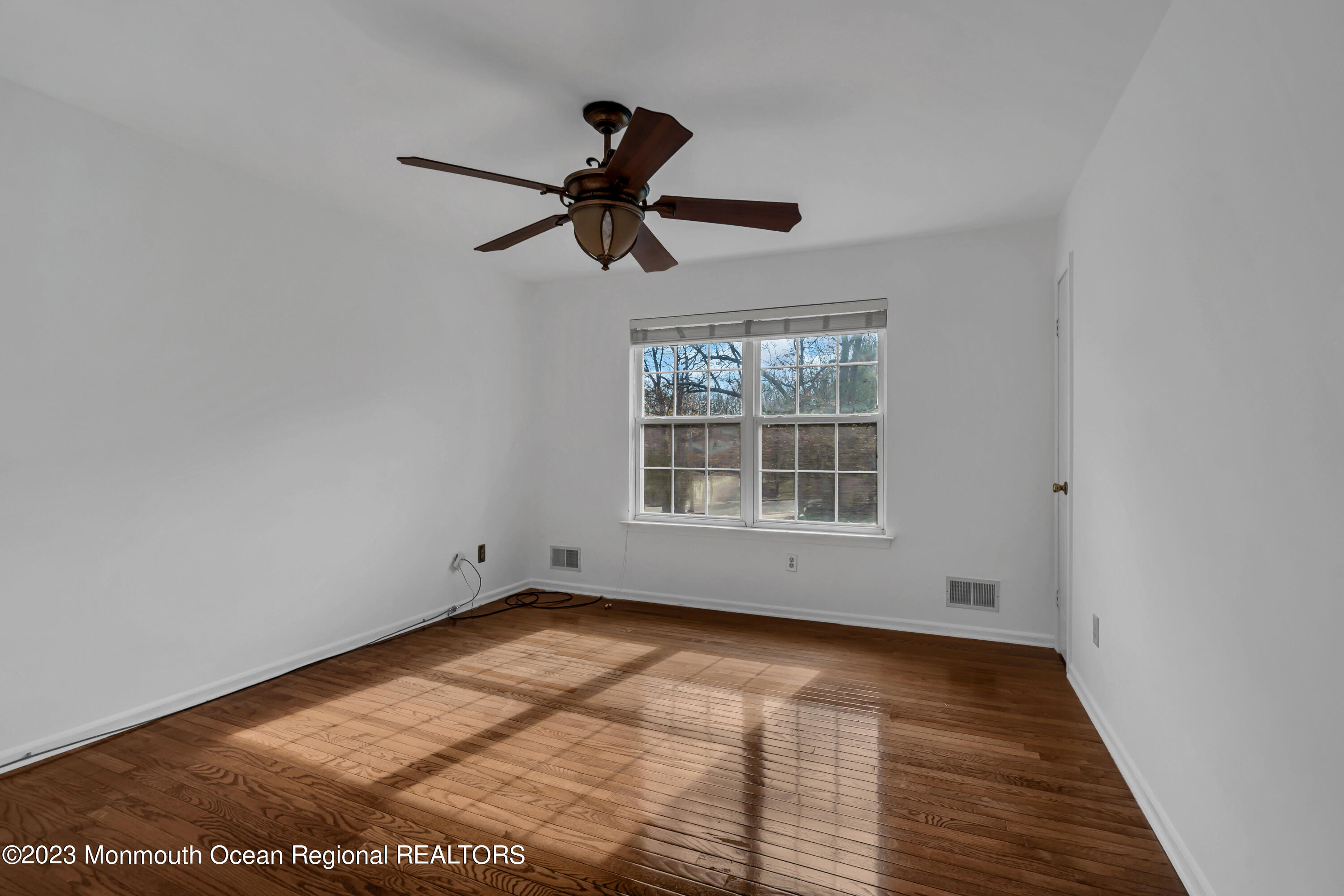 796 Harmony Road Jackson, NJ 08527 - Photo 17 of 22 a view of empty room with wooden floor and fan