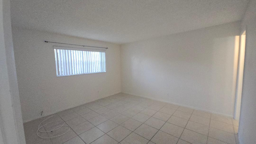 8040 North Colony Circle, Unit 102 Tamarac, FL 33321 - Photo 11 of 17 an empty room with windows