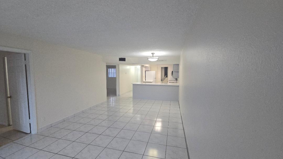 8040 North Colony Circle, Unit 102 Tamarac, FL 33321 - Photo 5 of 17 a view of a kitchen with an empty space and a window