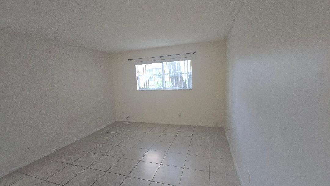 8040 North Colony Circle, Unit 102 Tamarac, FL 33321 - Photo 6 of 17 an empty room with windows