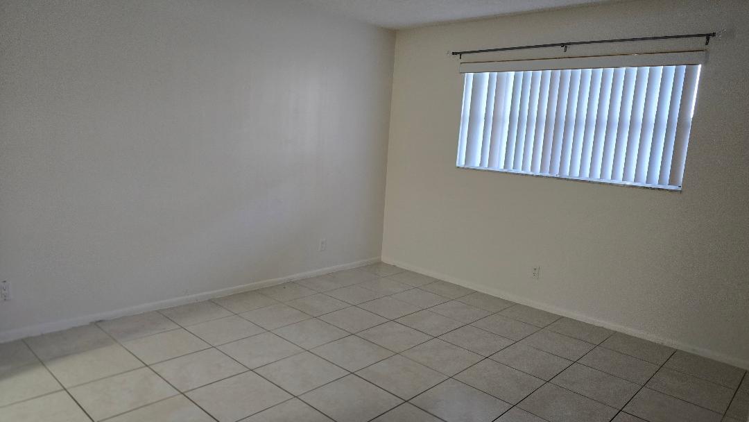 8040 North Colony Circle, Unit 102 Tamarac, FL 33321 - Photo 7 of 17 an empty room with windows