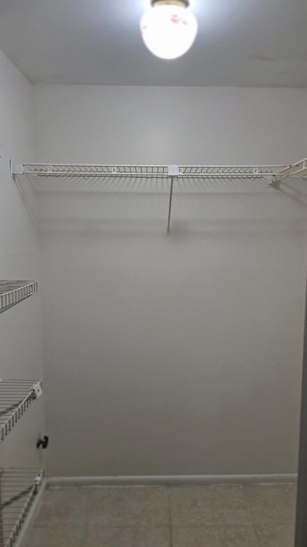 8040 North Colony Circle, Unit 102 Tamarac, FL 33321 - Photo 9 of 17 a view of a room with racks on the wall