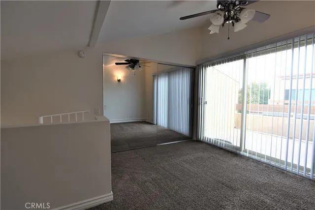 a view of a livingroom with a ceiling fan and window