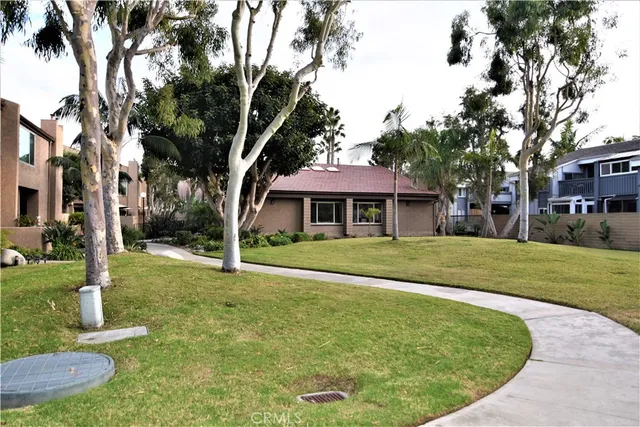 a view of a house with a small yard and plants