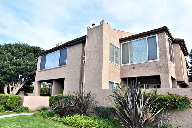 a view of a patio with a table and chairs under an umbrella