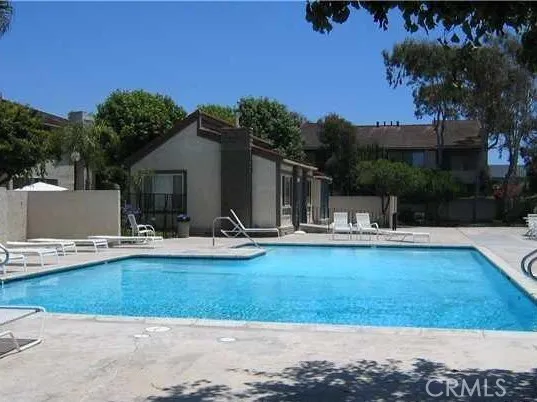 a view of a swimming pool with lounge chairs