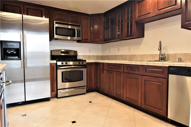 a kitchen with a sink stove and microwave