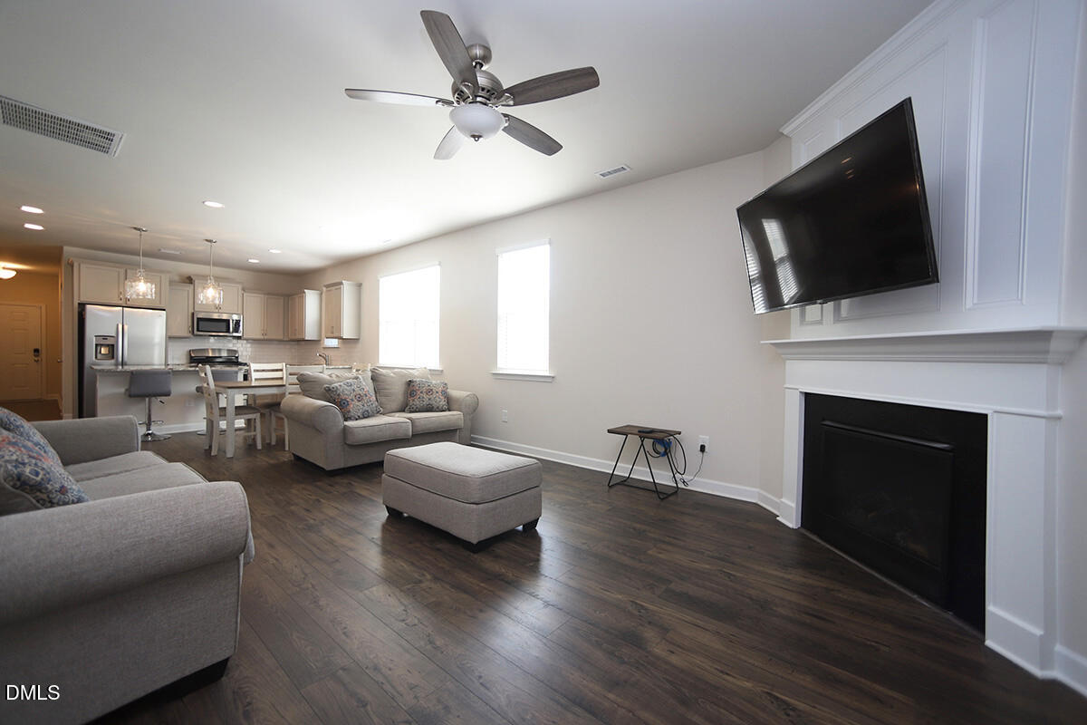 125 Mae Court Roxboro, NC 27573 - Photo 14 of 30 a living room with furniture a fireplace and a flat screen tv