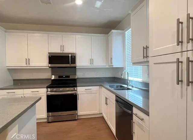 a kitchen with a stove and a sink