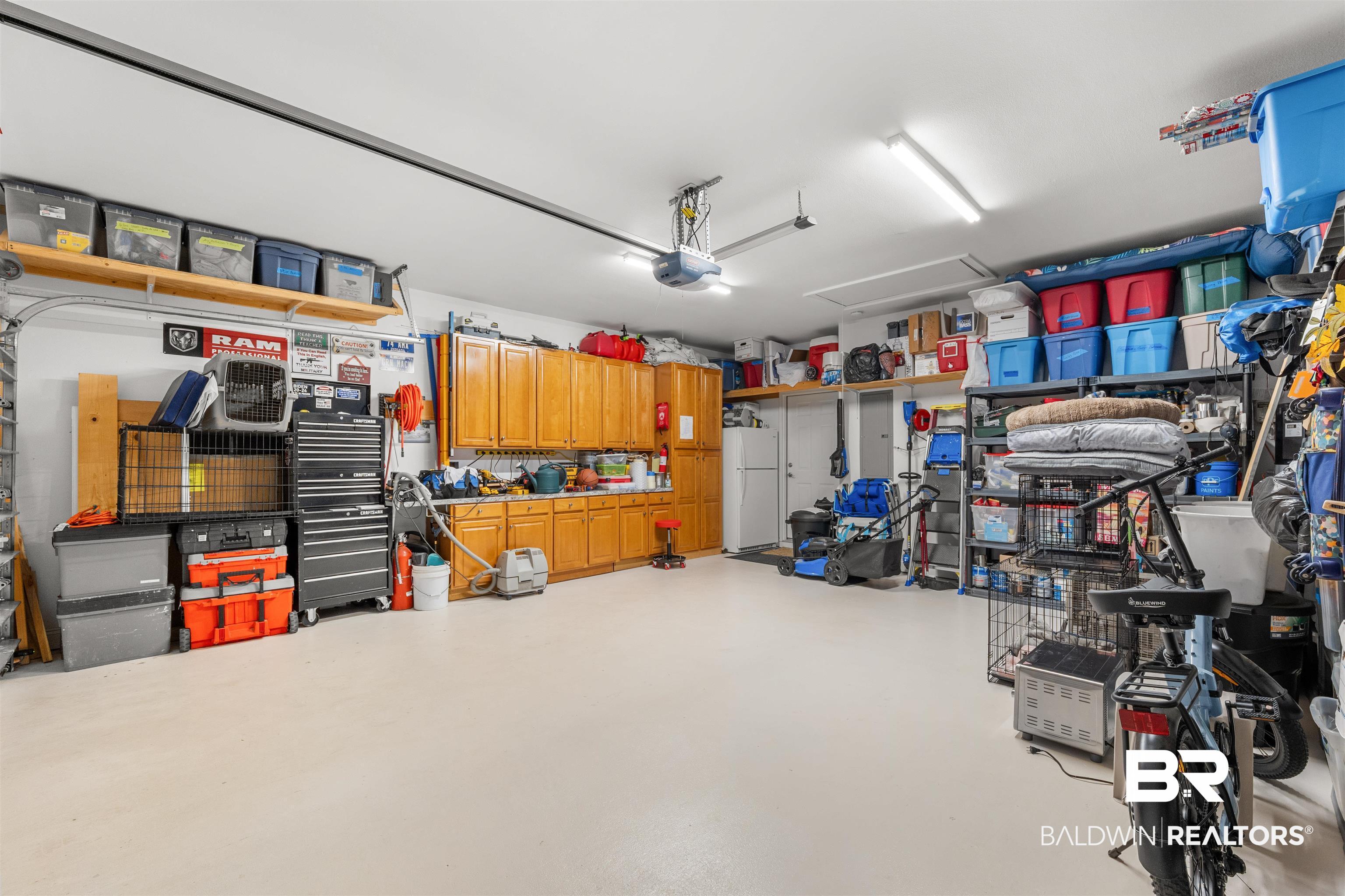 141 Mark Twain Loop Foley, AL 36535 - Photo 31 of 55 Garage featuring freestanding refrigerator and a garage door opener