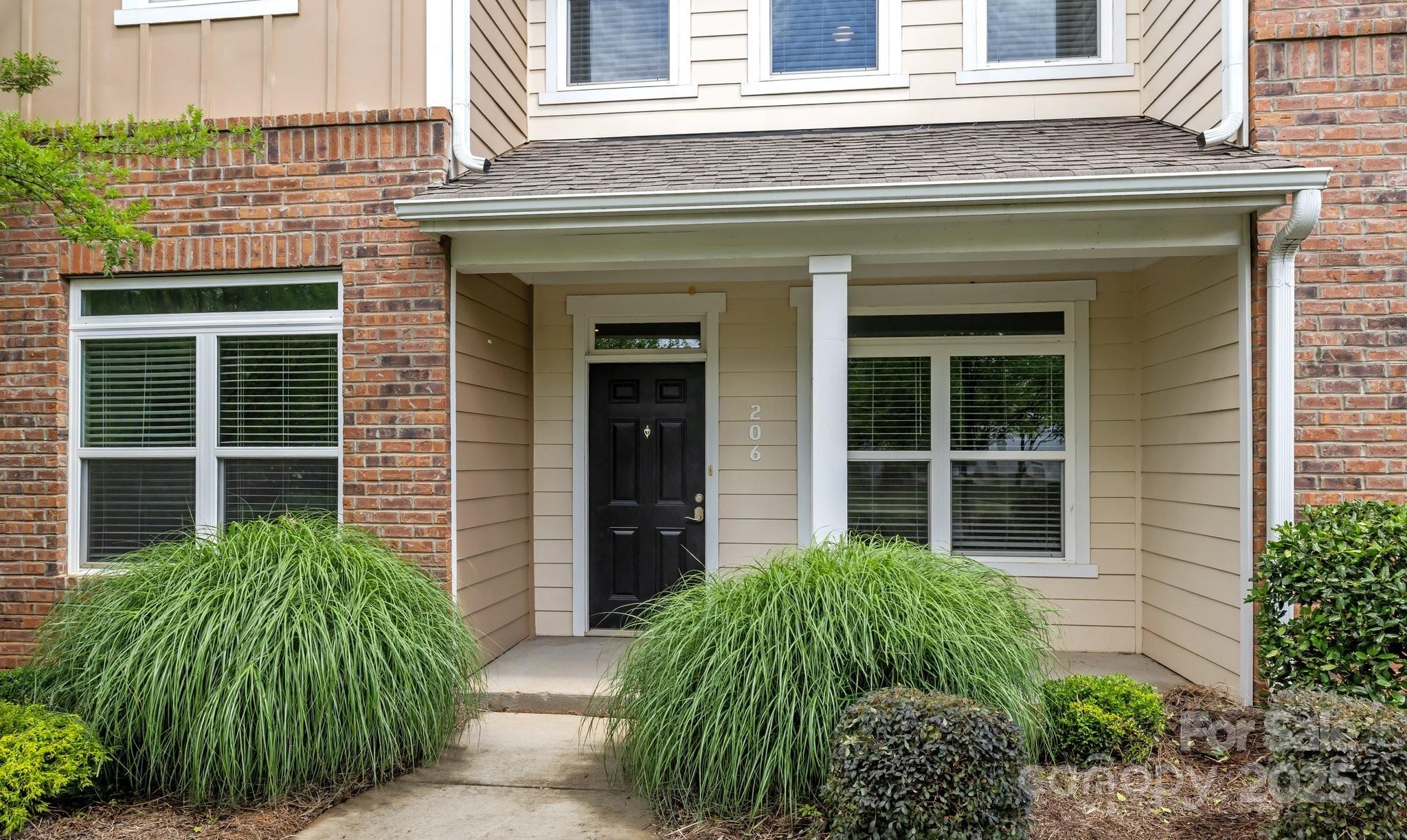 206 Overstone Court Fort Mill, SC 29715 - Photo 3 of 47 front view of a brick house with a large window