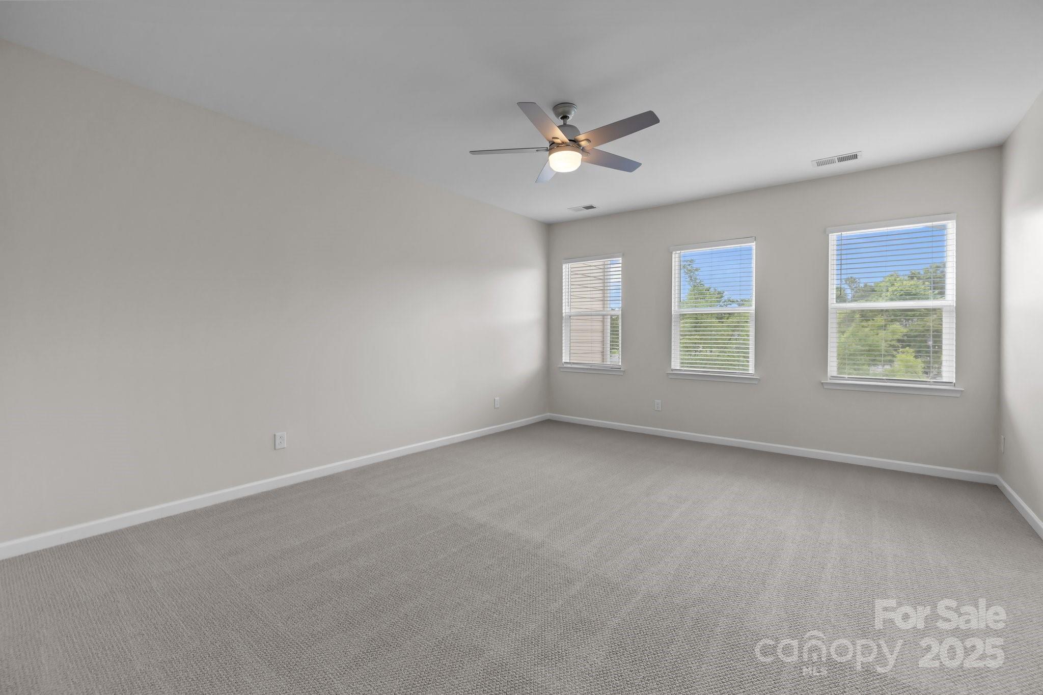 206 Overstone Court Fort Mill, SC 29715 - Photo 4 of 47 an empty room with windows and fan