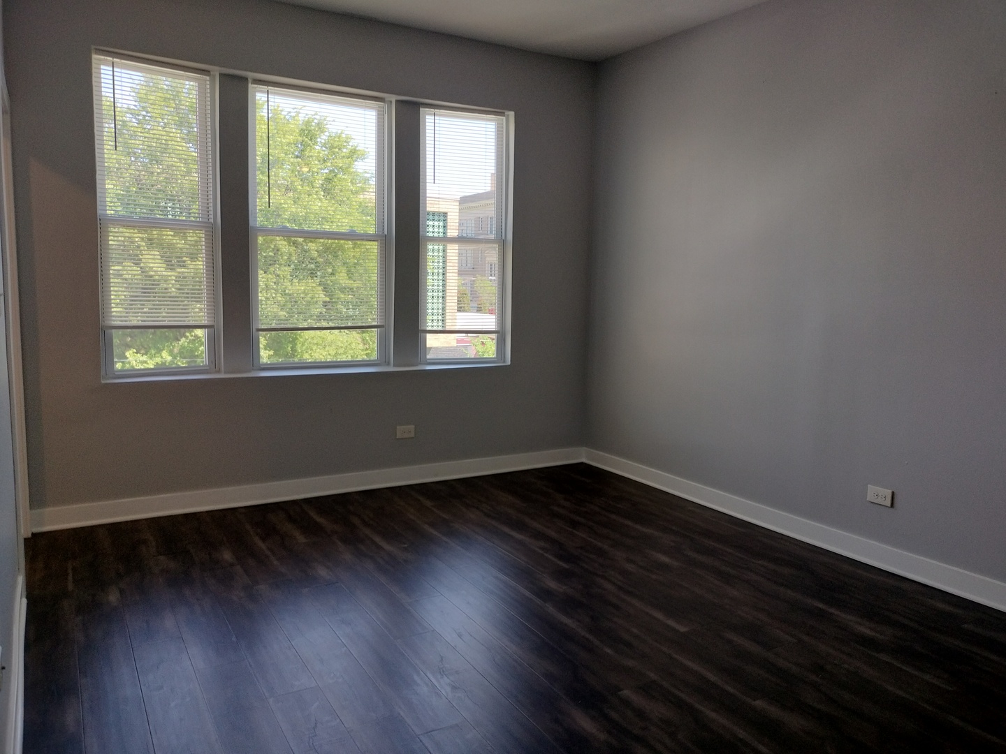 1943 West 48th Street, Unit 2 Chicago, IL 60609 - Photo 14 of 30 an empty room with wooden floor and windows