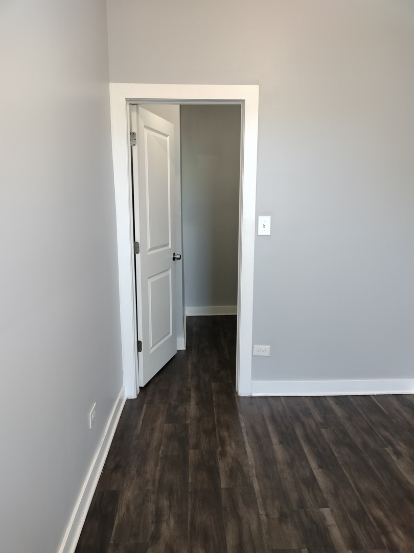 1943 West 48th Street, Unit 2 Chicago, IL 60609 - Photo 21 of 30 an empty room with wooden floor and entrance