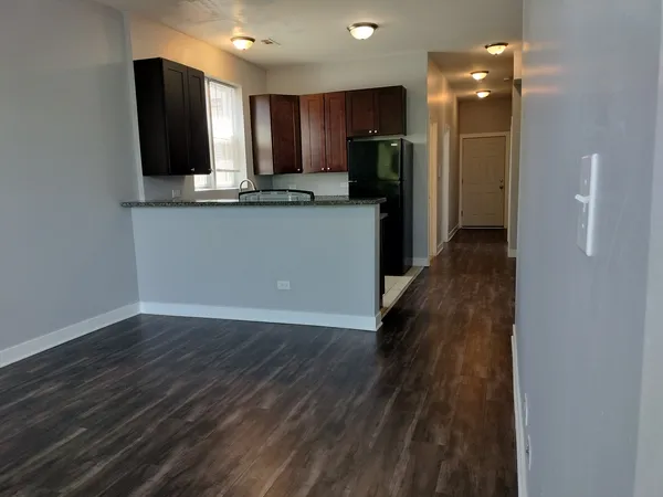 a kitchen with stainless steel appliances granite countertop a refrigerator and a sink