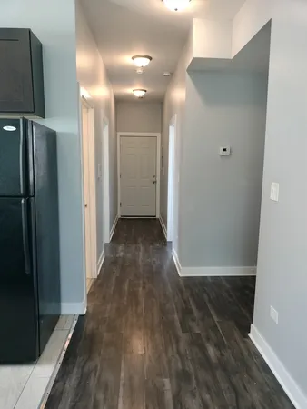 a view of hallway with wooden floor