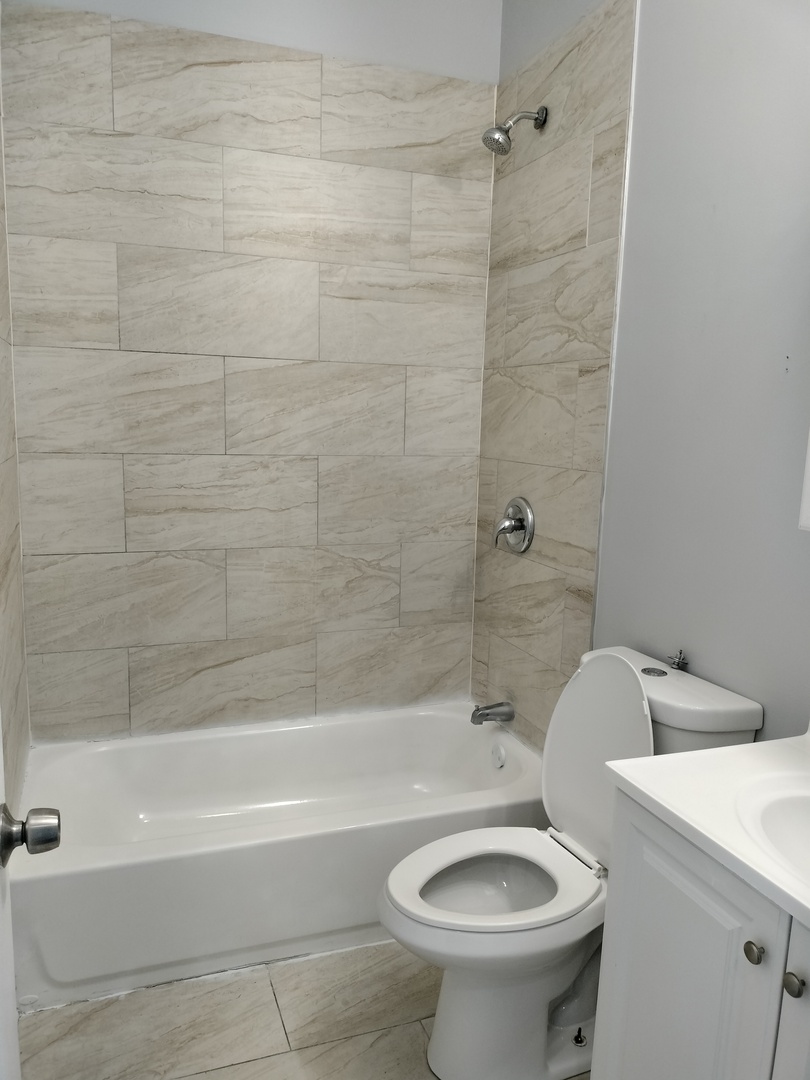 1943 West 48th Street, Unit 2 Chicago, IL 60609 - Photo 27 of 30 a bathroom with a sink a toilet and a bathtub