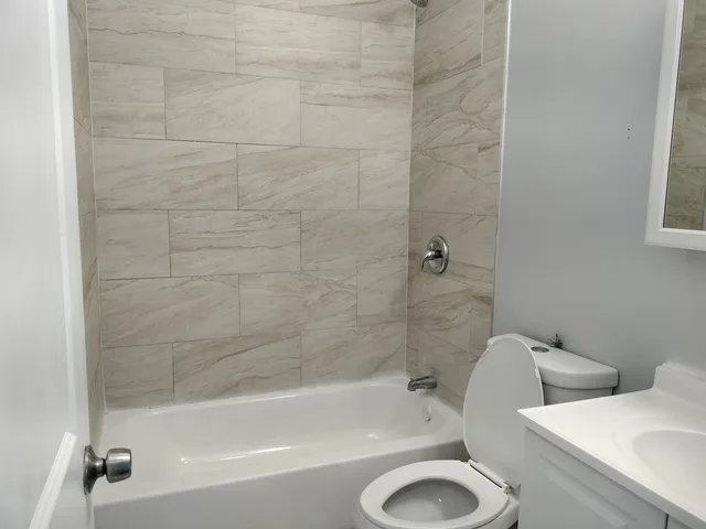 a bathroom with a toilet and a bathtub