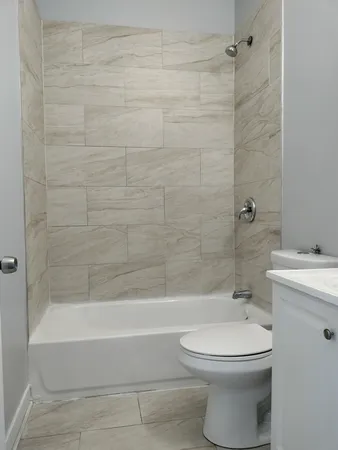 a bathroom with a toilet and a bathtub