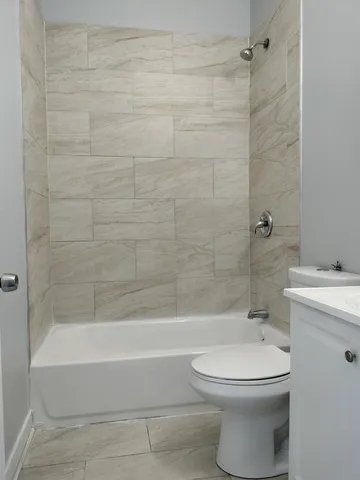 a bathroom with a toilet and a bathtub