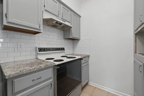 a kitchen with granite countertop a stove and a sink