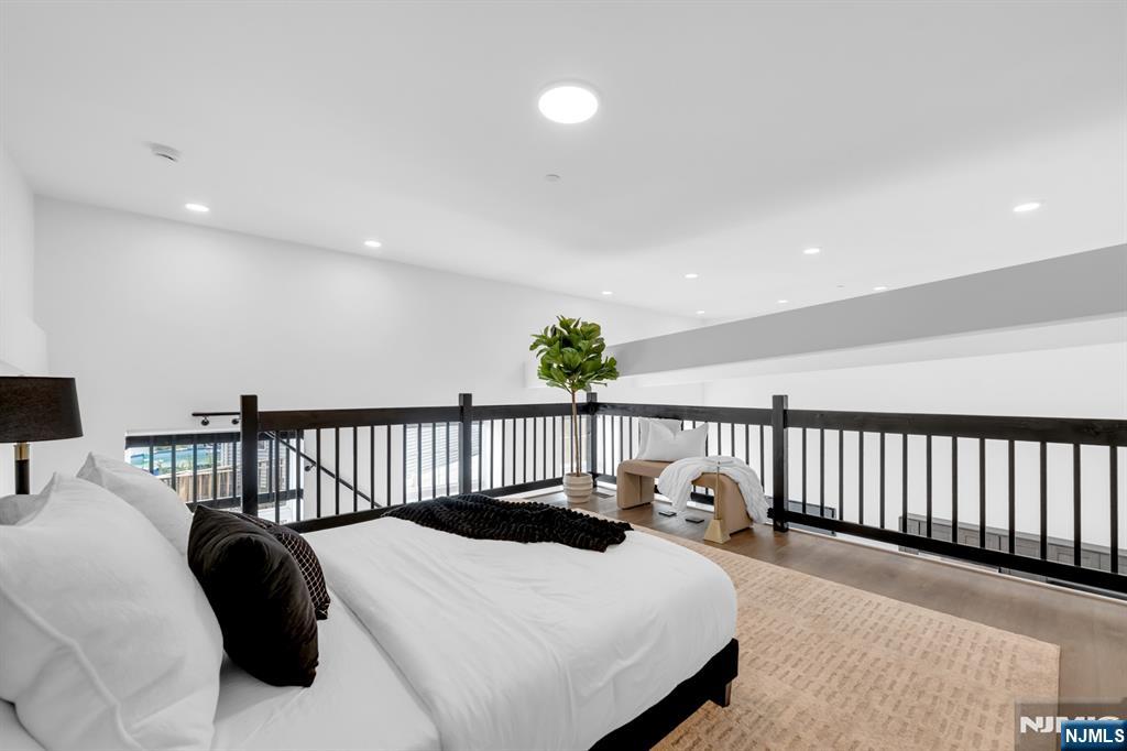 315 Railroad Avenue, Unit 108 East Rutherford, NJ 07073 - Photo 17 of 28 a bedroom with a bed and a chandelier