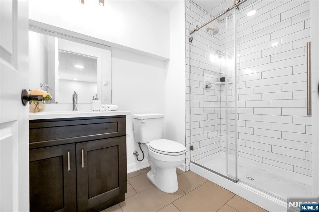 315 Railroad Avenue, Unit 108 East Rutherford, NJ 07073 - Photo 19 of 28 a bathroom with a sink toilet and shower