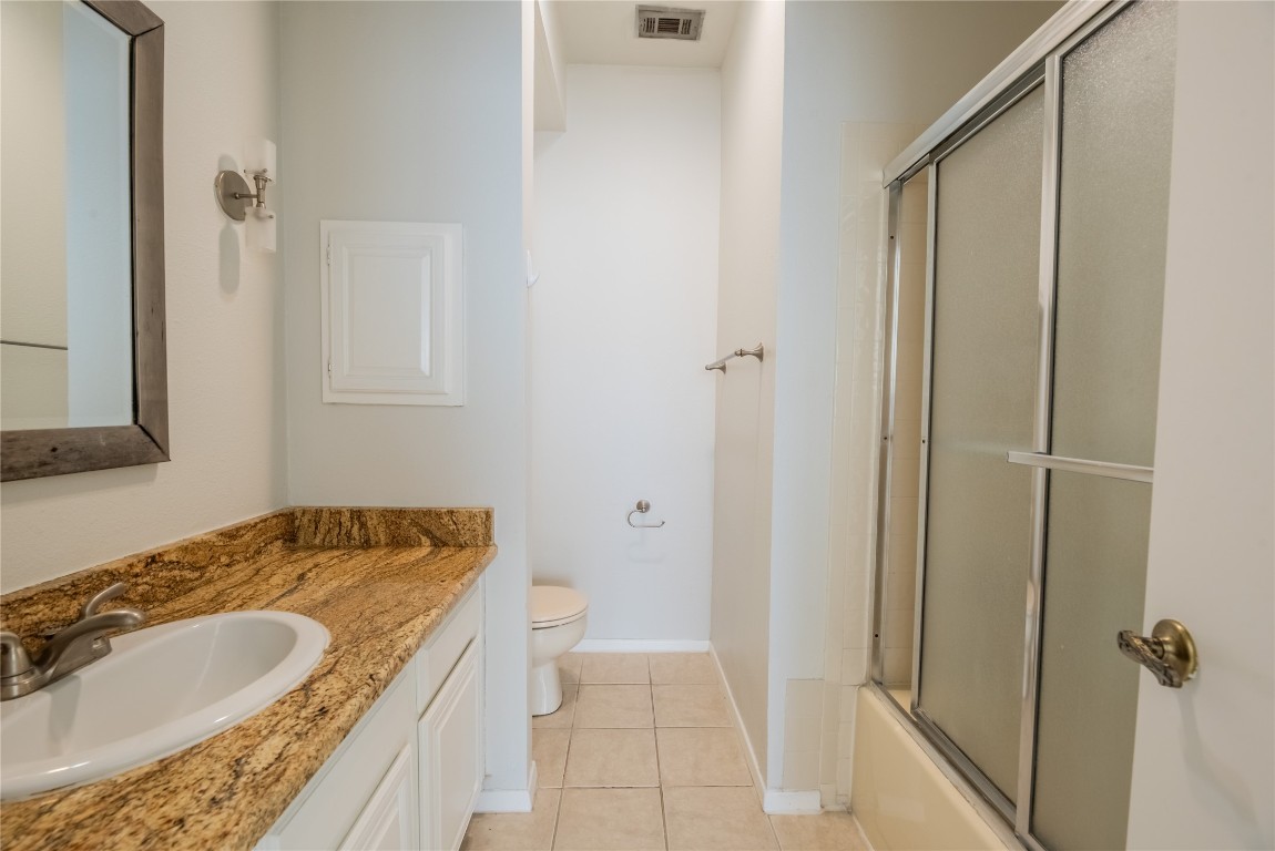 806 West 24th Street, Unit 236 Austin, TX 78705 - Photo 13 of 15 a bathroom with a granite countertop sink and a mirror