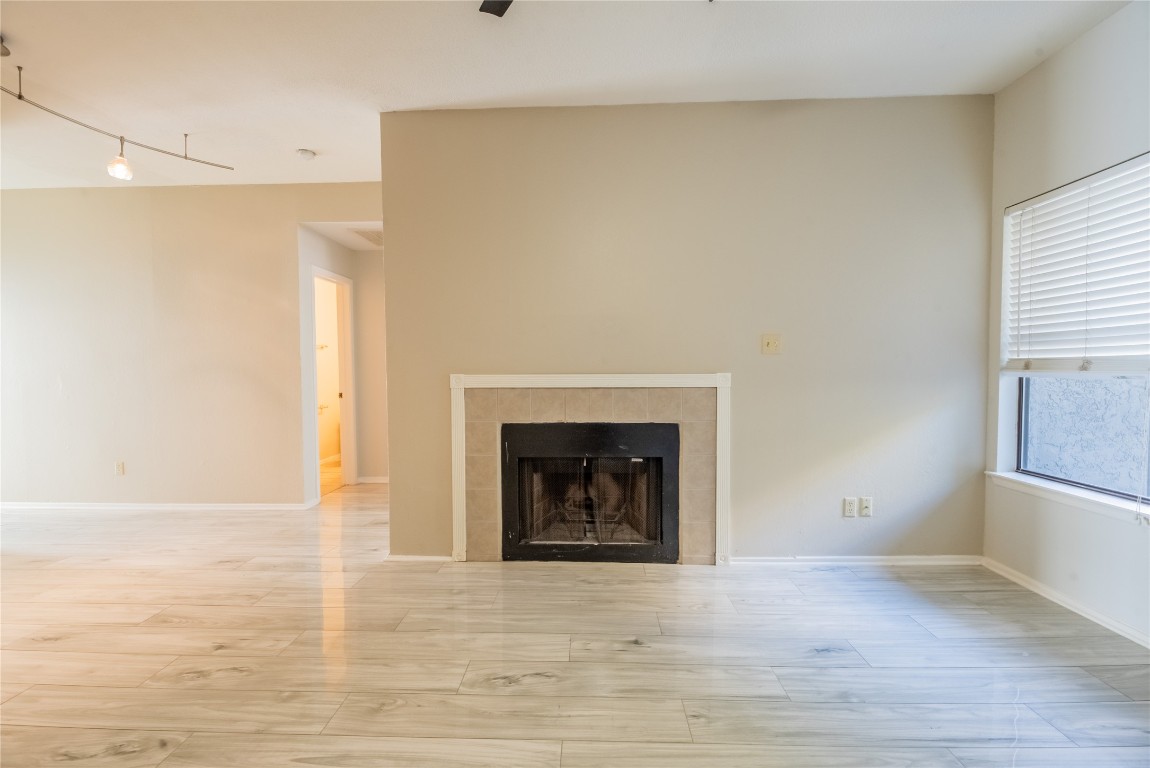 806 West 24th Street, Unit 236 Austin, TX 78705 - Photo 4 of 15 a view of an empty room with a fireplace and a window