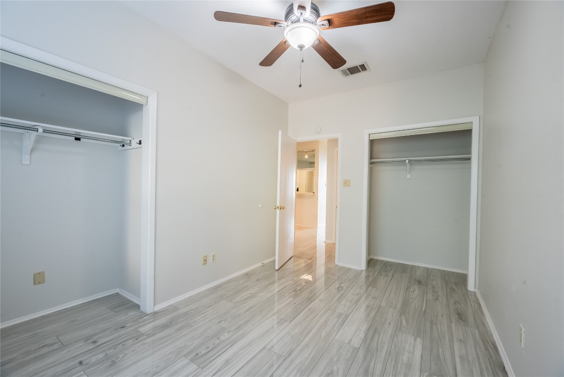 806 West 24th Street, Unit 236 Austin, TX 78705 - Photo 9 of 15 an empty room with wooden floor a ceiling fan and closet