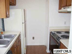 11089 Running Ridge Road, Unit 8493 Charlotte, NC 28226 - Photo 2 of 5 a kitchen with a sink stove and refrigerator